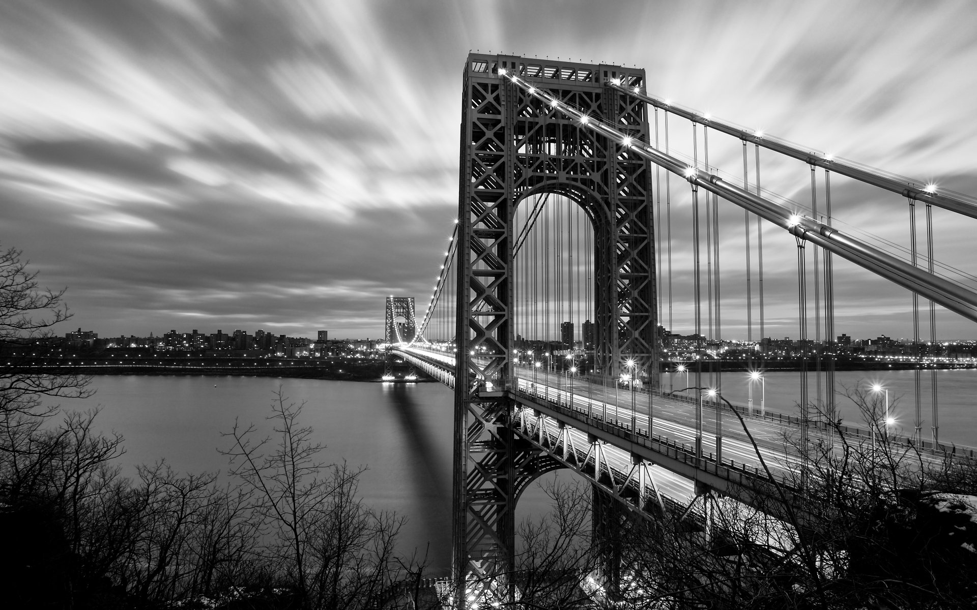 Black and white 4K Ultra HD image of the George Washington Bridge in New York, showcasing the man-made structure against a dramatic sky.