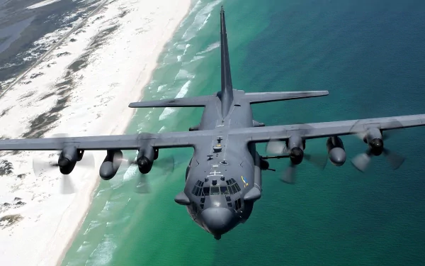 HD desktop wallpaper of a Lockheed AC-130 military aircraft flying over a coastal shoreline with clear waters and sandy beaches.