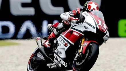 A dynamic Yamaha MotoGP motorcycle racing on the track, featuring a rider in sleek gear. This HD image serves as an engaging desktop wallpaper and background.