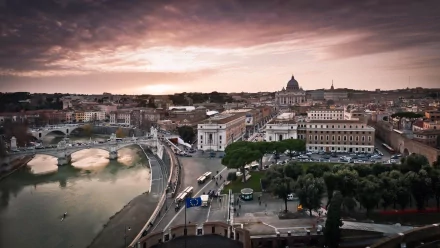 A stunning HD wallpaper showcasing Rome's iconic architecture at sunset, featuring the Tiber River and St. Peter's Basilica in the distance, capturing the city's vibrant atmosphere.