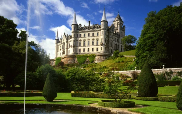 Man-made Dunrobin Castle HD PC desktop wallpaper/background: grand Scottish castle on terraced gardens with fountain under a bright blue sky