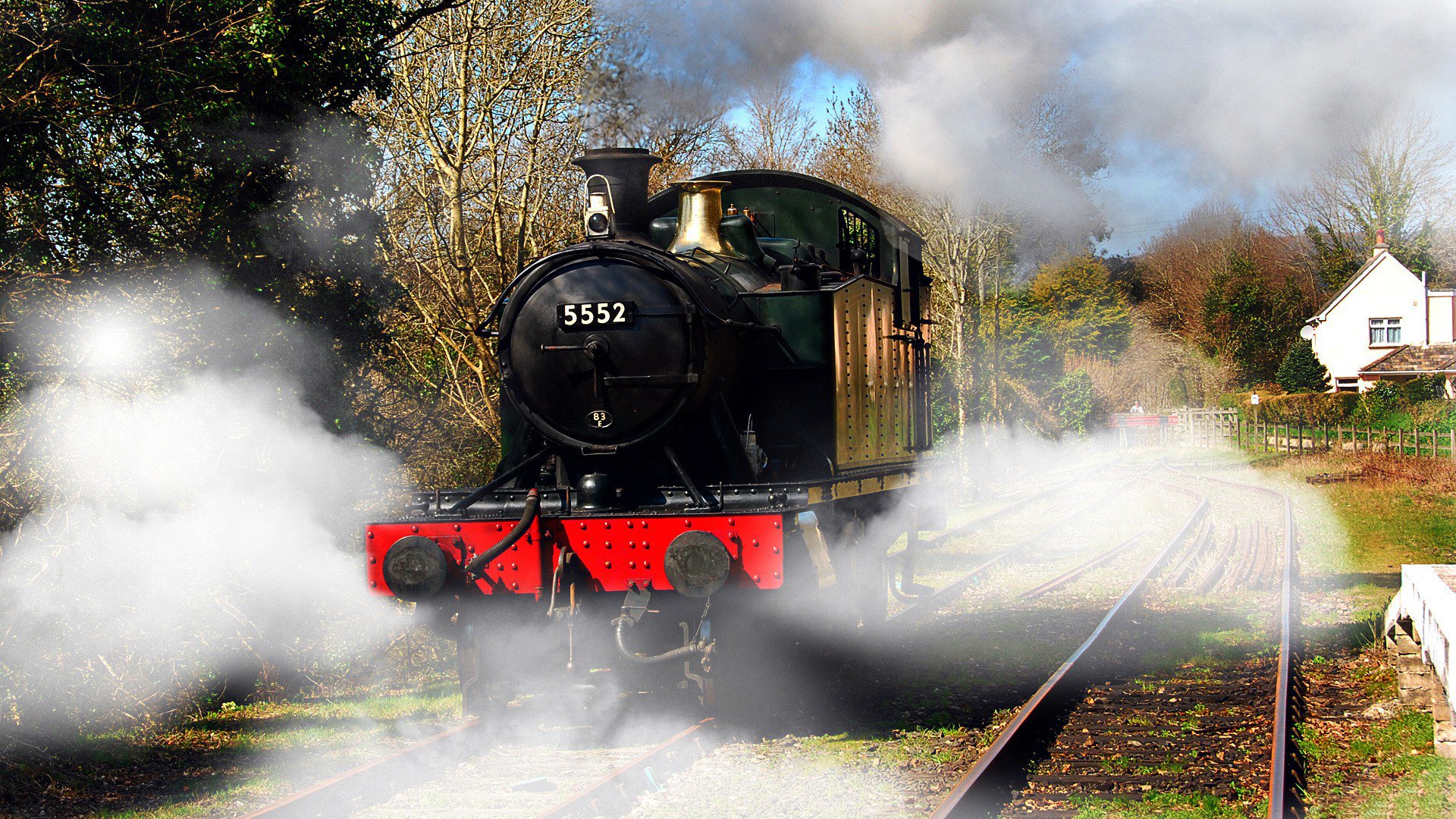 HD desktop wallpaper featuring a vintage steam locomotive numbered 5352, surrounded by billowing white steam on railway tracks in a scenic outdoor setting.