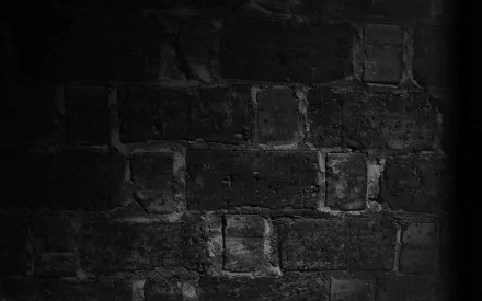 HD photography of a weathered brick wall in dark grayscale, PC desktop wallpaper and background with a dramatic side shadow.