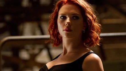 A striking HD desktop wallpaper featuring Scarlett Johansson, showcasing her stylish look and captivating presence in a dramatic setting.