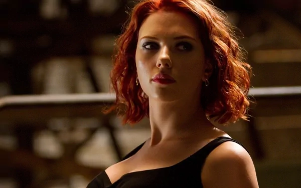A striking HD desktop wallpaper featuring Scarlett Johansson, showcasing her stylish look and captivating presence in a dramatic setting.