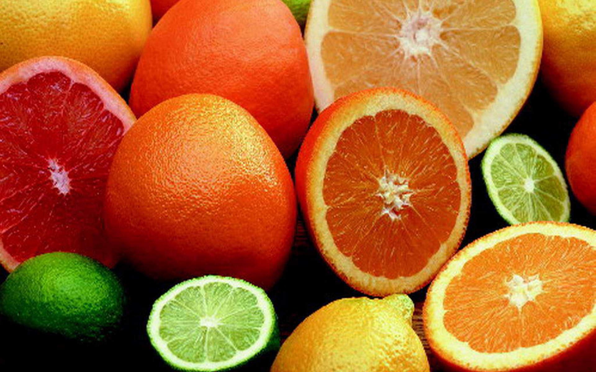 HD PC desktop wallpaper featuring a vibrant assortment of fresh citrus fruits, including oranges, limes, lemons, and grapefruits.