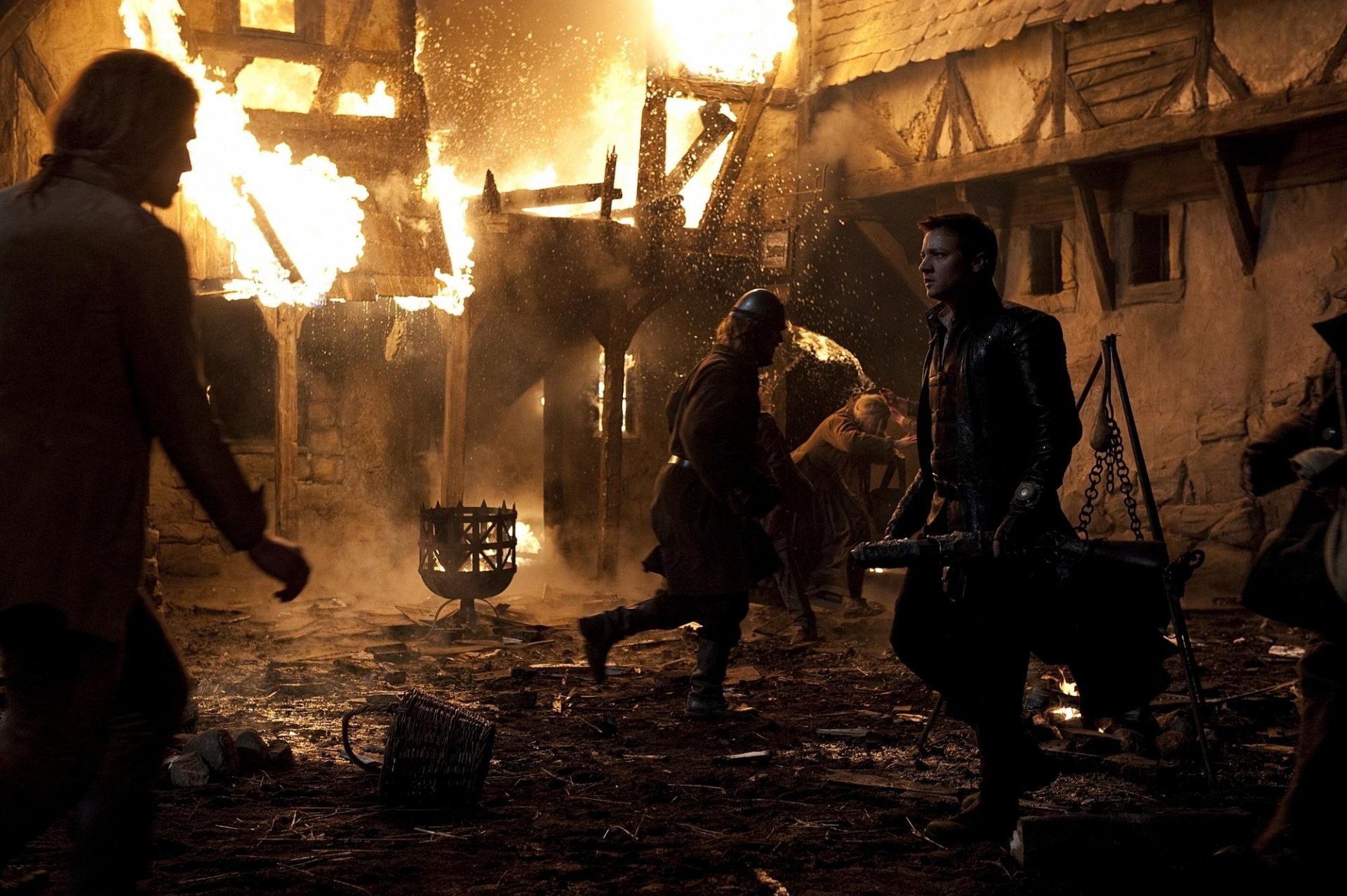 HD PC desktop wallpaper from the movie Hansel & Gretel: Witch Hunters, featuring characters amid a burning village scene.