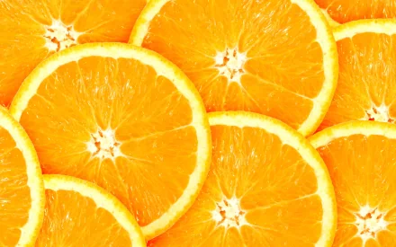 HD PC desktop wallpaper featuring close-up slices of vibrant orange fruit, highlighting the bright orange color and fresh texture of the food.