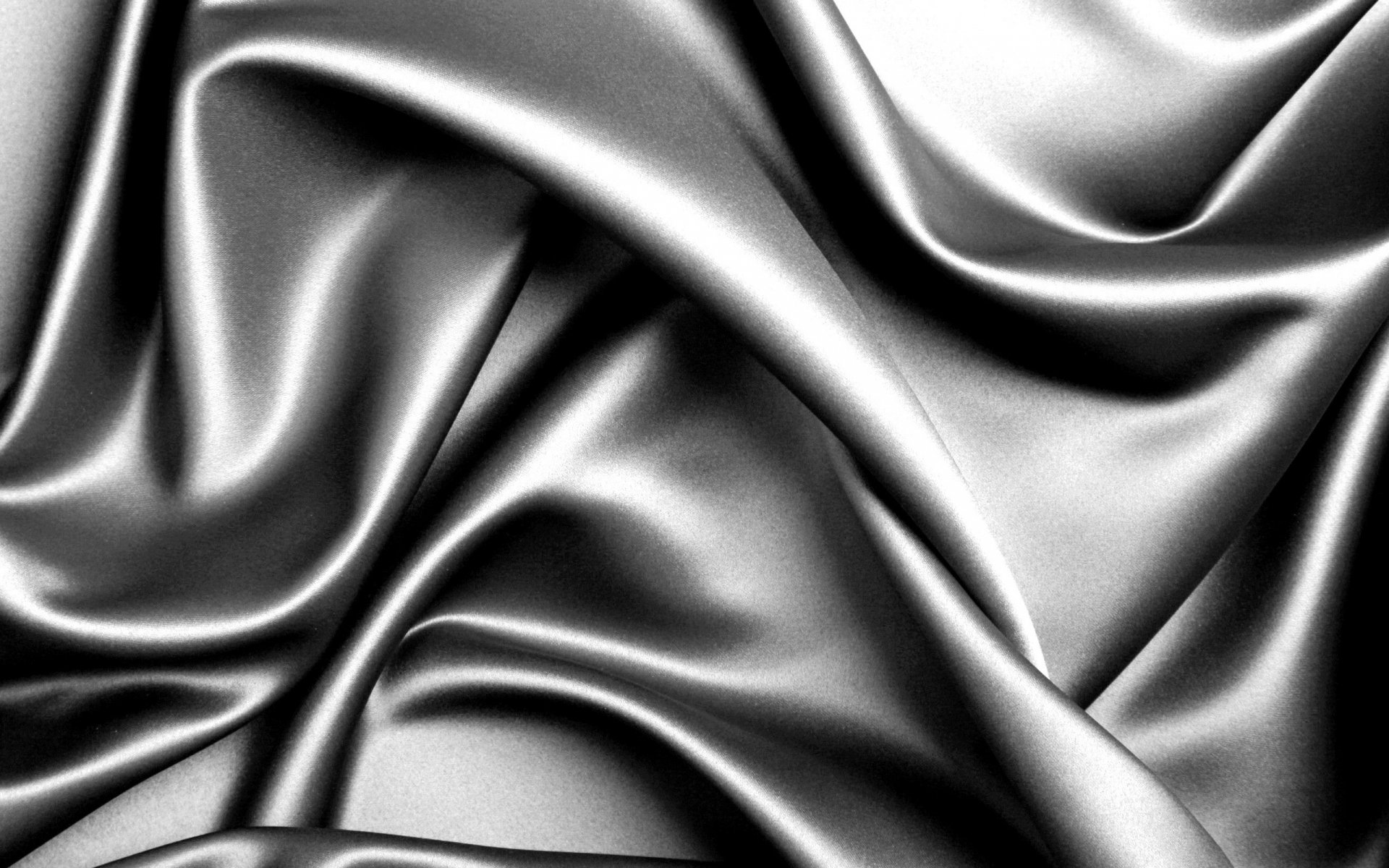 Abstract black fabric forms a smooth, flowing pattern, creating an elegant and sophisticated desktop wallpaper and background for HD displays.