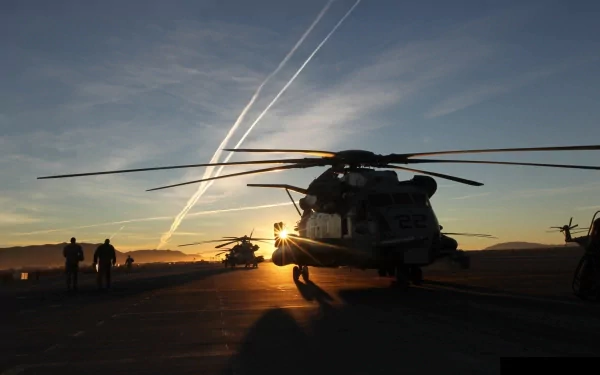 Military Sikorsky CH-53E Super Stallion helicopters are shown on a runway at sunset in this HD desktop wallpaper and background.