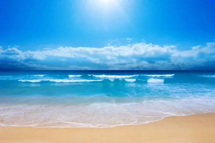 HD desktop wallpaper and background featuring a tranquil beach scene with waves lapping against sandy shores, a clear blue sky, fluffy clouds, and the vast horizon. Nature's beauty at the oceanfront.