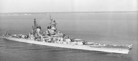 Black and white HD desktop wallpaper of the USS Wisconsin (BB-64) battleship cruising on calm waters, showcasing its military design and powerful armament.