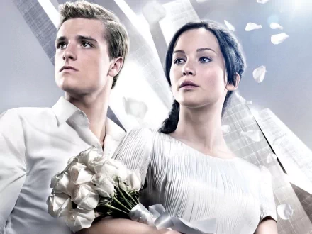HD PC desktop wallpaper featuring characters from the movie The Hunger Games: Catching Fire, with a soft, light-filled background.