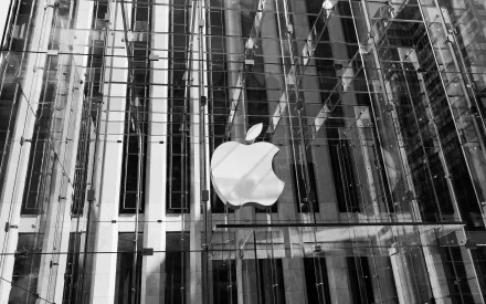 Black and white HD desktop wallpaper featuring the modern glass architecture of a man-made Apple Store with the iconic Apple logo prominently displayed.