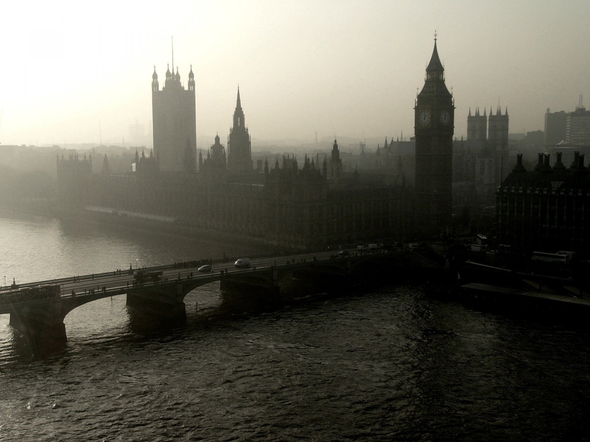 HD desktop wallpaper featuring a misty view of London with Big Ben and adjacent man-made structures along the river.
