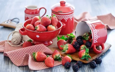 HD PC desktop wallpaper featuring fresh strawberries and blackberries in red and white kitchenware on a checkered cloth, showcasing vibrant, appetizing berries.