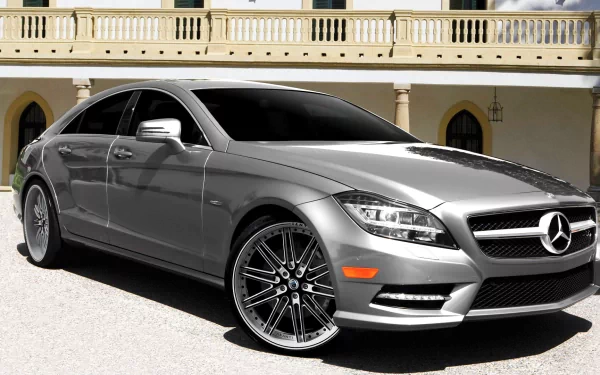 Silver Mercedes‑Benz sedan parked before a Mediterranean-style villa — HD PC Desktop Wallpaper and Background vehicle image.