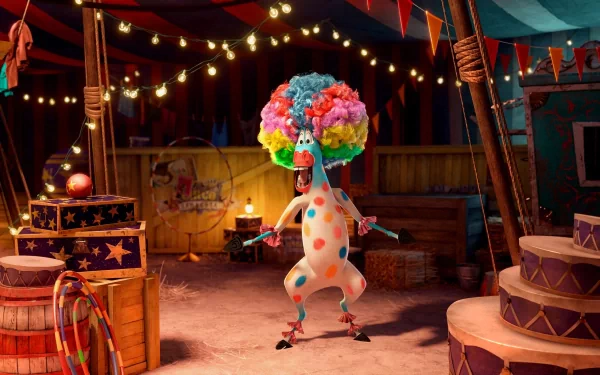 Madagascar 3: Europe's Most Wanted movie scene - colorful clown giraffe performing in a lit circus tent, vibrant 2K Quad HD PC desktop wallpaper/background.