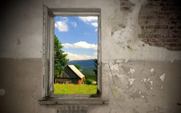 HD desktop wallpaper featuring a man-made window opening to a scenic rural landscape with a barn, green grass, and a bright blue sky with clouds.