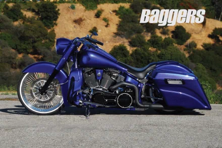 Blue Harley-Davidson Softail Deluxe motorcycle parked on a road with hills in the background, featured as an HD PC desktop wallpaper and background.