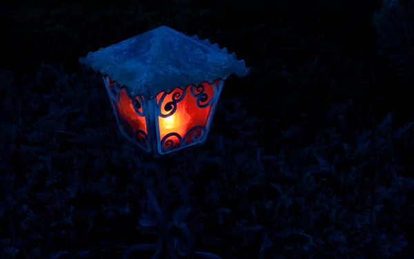 HD PC desktop wallpaper featuring a glowing man-made lantern with ornate designs, casting warm light in a dark outdoor setting.
