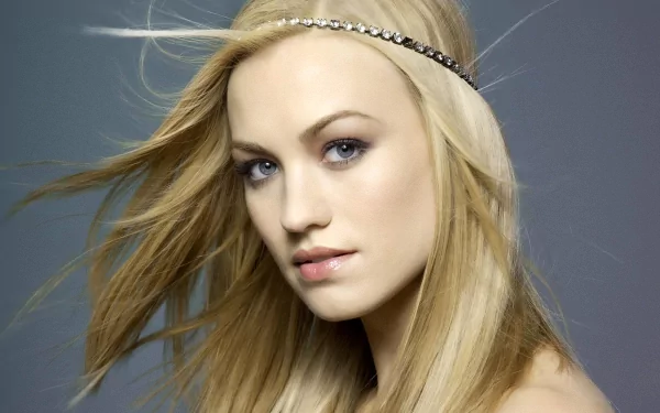 HD desktop wallpaper featuring a close-up portrait of celebrity Yvonne Strahovski with flowing blonde hair and a delicate headband against a gray background.