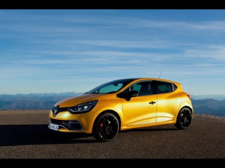 Yellow 2013 Renault Clio RS 200 EDC parked on a scenic road with a clear blue sky, captured as an HD PC desktop wallpaper and background.