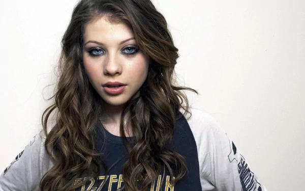 HD PC desktop wallpaper featuring celebrity Michelle Trachtenberg with loose wavy hair and smoky eye makeup against a plain white background.
