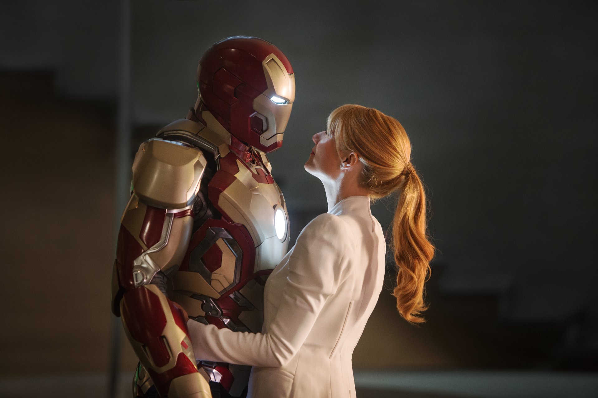 A cinematic moment from Iron Man 3, showcasing Iron Man and Pepper Potts in a tender embrace, captured in stunning HD for a striking desktop wallpaper.