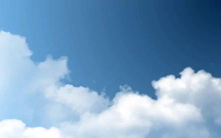 HD desktop wallpaper featuring a clear blue sky with fluffy white clouds, capturing the serene beauty of nature.
