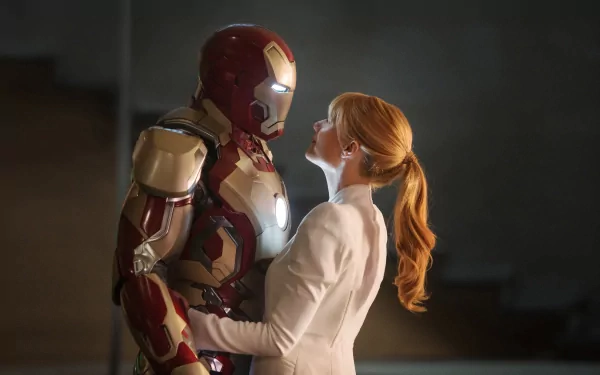 A cinematic moment from Iron Man 3, showcasing Iron Man and Pepper Potts in a tender embrace, captured in stunning HD for a striking desktop wallpaper.