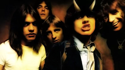 A vibrant HD wallpaper featuring Angus Young and the band AC/DC, capturing their dynamic presence and iconic energy in a striking background.