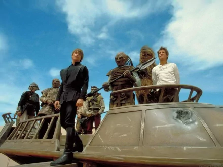 HD PC desktop wallpaper featuring a scene from the movie Star Wars Episode VI: Return of the Jedi with key characters standing on a vehicle under a blue sky.