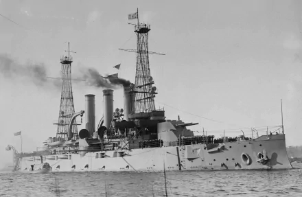 Black and white 4K Ultra HD image of the USS Kansas (BB-21), a United States Navy battleship, captured at sea with smokestacks and signal masts visible.
