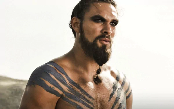 HD wallpaper featuring Jason Momoa as Drogo from Game of Thrones, showcasing his striking tattoos and intense expression against a dramatic backdrop.