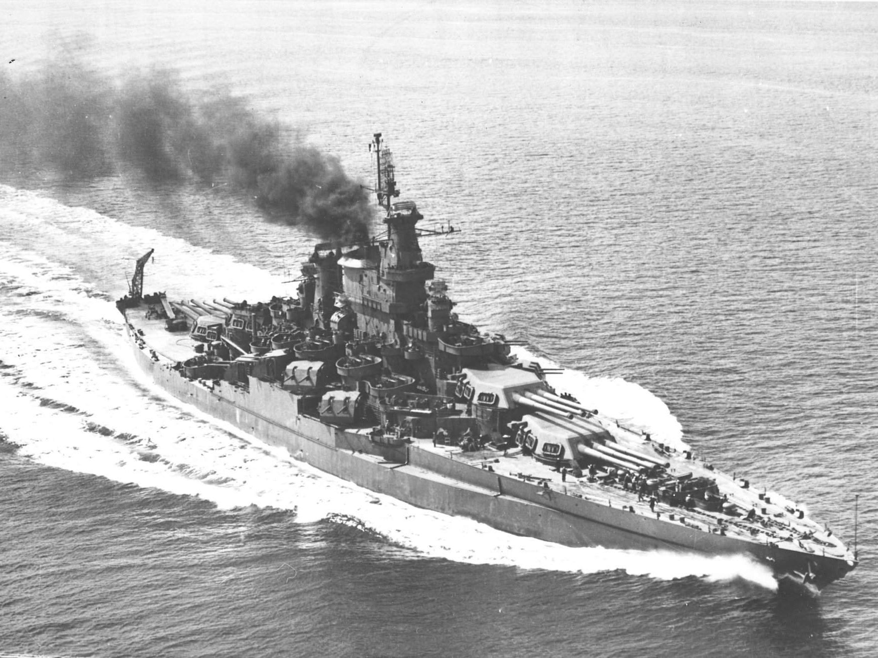 HD PC desktop wallpaper of warship USS California (BB-44): a WWII-era battleship steaming at sea with smoke plume; military vessel in motion.