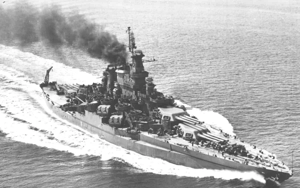 HD PC desktop wallpaper of warship USS California (BB-44): a WWII-era battleship steaming at sea with smoke plume; military vessel in motion.