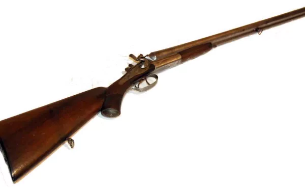 HD desktop wallpaper featuring a detailed man-made antique shotgun with a wooden stock and metal barrel on a white background.