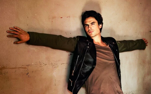 HD desktop wallpaper featuring celebrity Ian Somerhalder, with his arms outstretched against a textured wall background.
