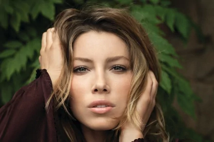 A captivating HD desktop wallpaper featuring celebrity Jessica Biel, showcasing her natural beauty against a backdrop of lush greenery.