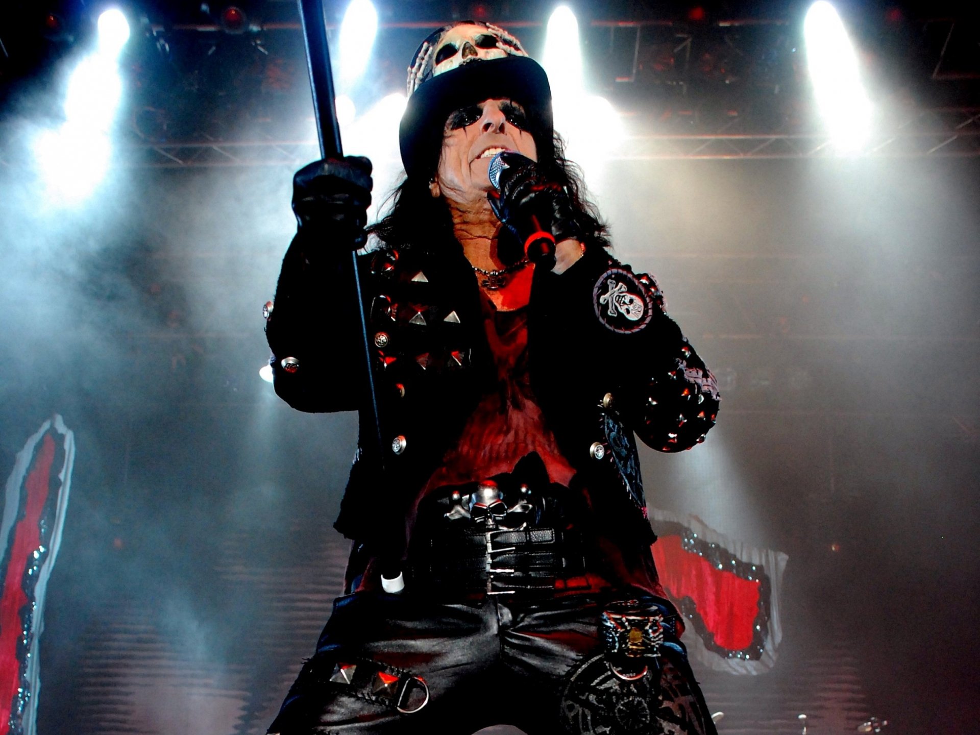 HD PC desktop wallpaper featuring rock musician Alice Cooper performing on stage with dramatic lighting and fog effects.