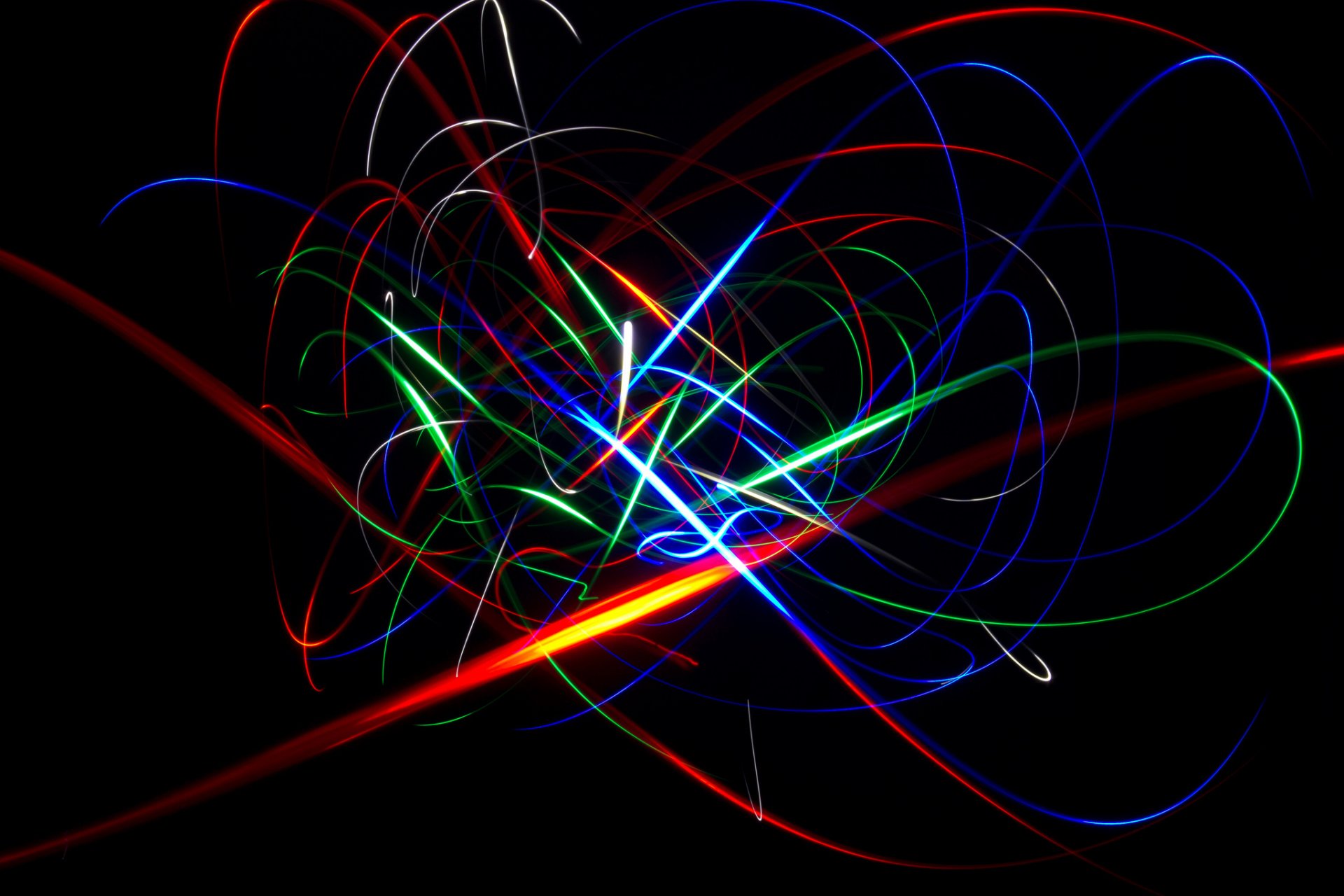 Abstract HD PC desktop wallpaper featuring vibrant, colorful light trails on a black background, creating dynamic and vivid swirling patterns.