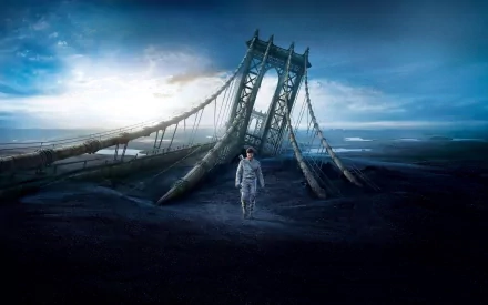 HD desktop wallpaper featuring Tom Cruise from the 2013 movie Oblivion, standing in front of a partially submerged, collapsed suspension bridge under a dramatic sky.