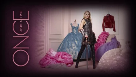 Emma Swan stands confidently in a warrior outfit, sword in hand, surrounded by colorful dresses from the TV show Once Upon A Time. The image captures her strong character amidst fairytale elements.
