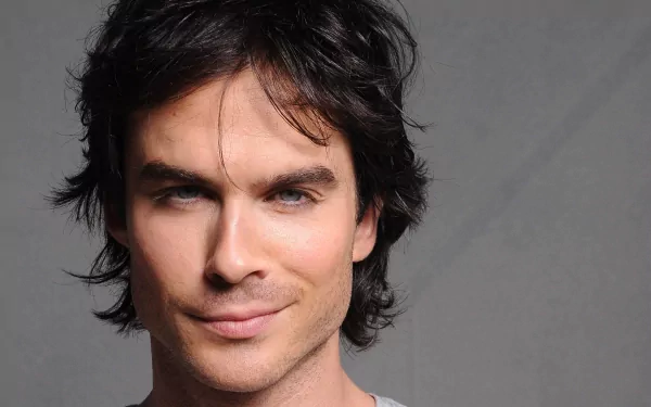 HD desktop wallpaper featuring celebrity Ian Somerhalder against a gray background, showcasing his piercing blue eyes and confident expression.