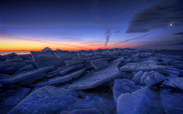 HD nature desktop wallpaper featuring vast ice formations under a twilight sky with vibrant hues of blue and orange blending at the horizon.