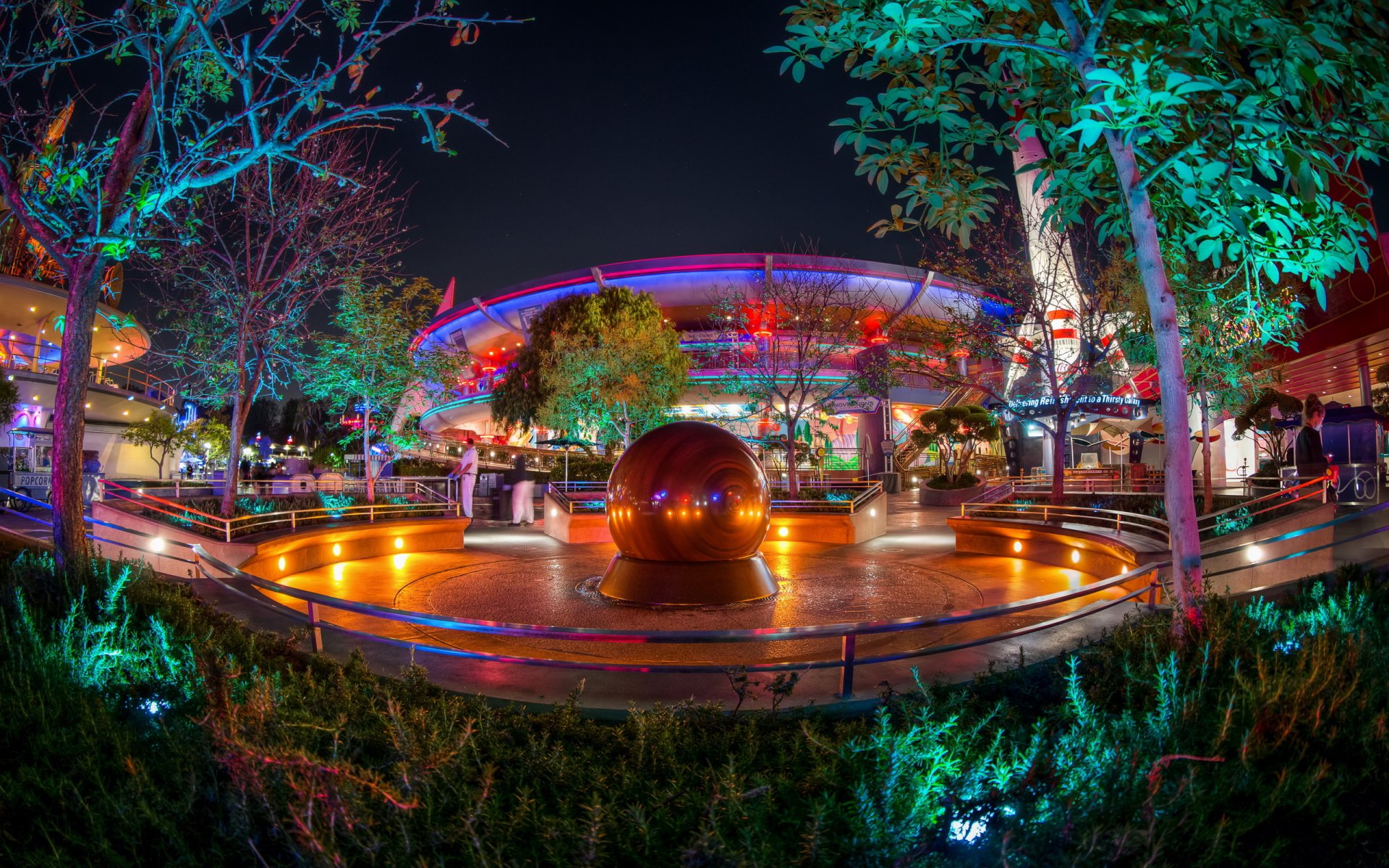 Vibrantly lit man-made building and fountain in a landscaped outdoor area, captured as an HD PC desktop wallpaper and background at night.