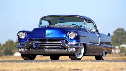 A vivid blue 1956 Cadillac captured in high definition, presented as a striking PC desktop wallpaper with clear details and classic vintage design.