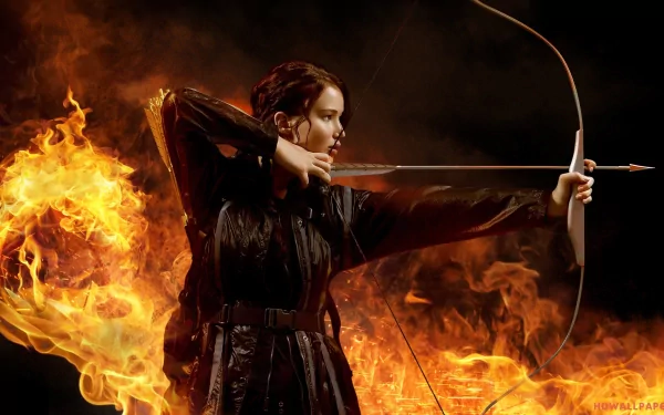 A powerful image of Katniss Everdeen, portrayed by Jennifer Lawrence, drawing her bow against a backdrop of swirling flames, capturing the fierce spirit of The Hunger Games.