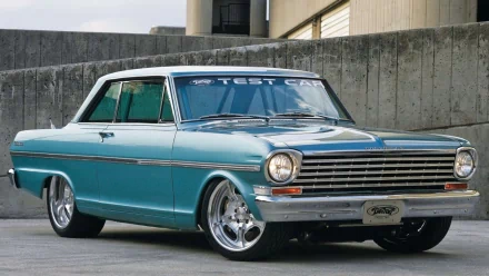 HD desktop wallpaper featuring a teal 1963 Chevrolet Nova, showcasing classic design and polished chrome details against a concrete urban backdrop.